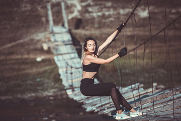 Young beautiful sportive girl. Girl is exercising. Outdoor sport. Beautiful strong sexy athletic caucasian fitness woman. Woman fitness outdoor concept