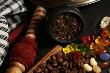 bowl with tobacco for hookah. fruits and berries on a black background. smoke hookah
