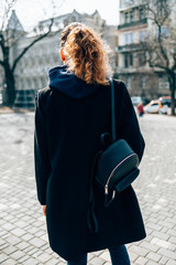 Back view young woman with curly hair