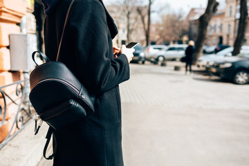 Side view young woman wearing elegant black coat