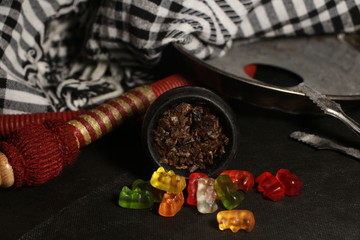 bowl with tobacco for hookah. berries on a black background. smoking sheesha