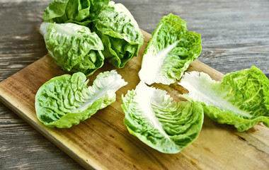 a lot of fresh Romaine lettuce on wooden floor..Healthy and benefits of green leaf lettuce.