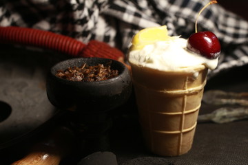 bowl with tobacco for hookah. fruits and berries on a black background. smoke hookah