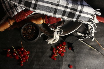 bowl with tobacco for hookah. fruits on a black background