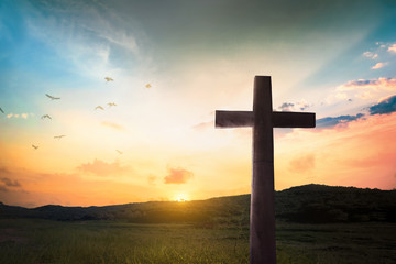 Religious concept: Jesus Christ wooden cross with dramatic lighting background