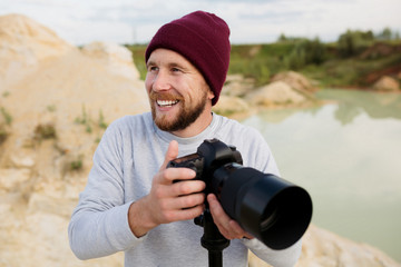 Photographer tourist defiantly a fun and photographing the wildlife with a tripod