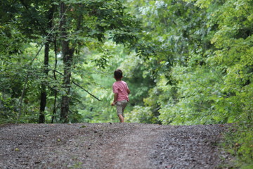 Child walking in the forest