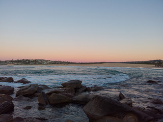 Obraz na płótnie Canvas Rocky beach view with clear morning sky.