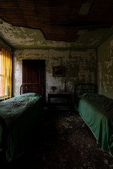Derelict Furniture with Beds + Tattered Curtains - Abandoned Wyoming Hotel - Mullens, West Virginia