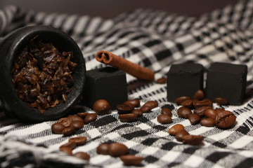 bowl with tobacco for hookah. berries on a black background