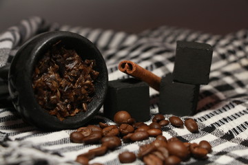 bowl with tobacco for hookah. berries on a black background. smoking hooka