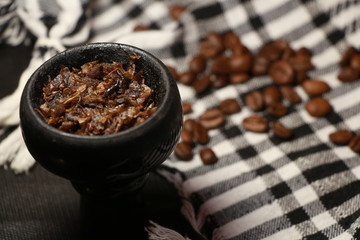 bowl with tobacco for hookah. fruits on a black background