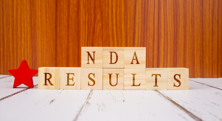 Concpet of NDA exam conducted in India for recruitment, NDA Exam results on Wooden block letters.
