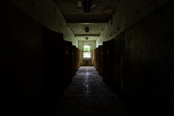 Fototapeta na wymiar Derelict Dark Hallway - Abandoned Creedmoor State Hospital - Queens, New York City, New York