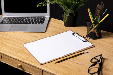 Tidy desk with clipboard and glasses