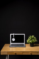 Fototapeta premium Wooden desk with laptop and headphones