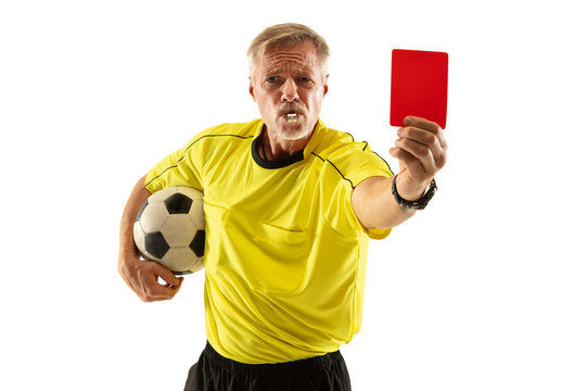 Referee holding ball and showing a red card to a football or soccer player while gaming on white studio background. Concept of sport, rules violation, controversial issues, obstacles overcoming.