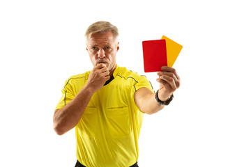 Referee showing a red and yellow cards to a football or soccer player while gaming on white studio...