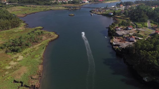 man riding a jet ski on a river, aerial view from drone