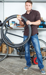 Male is holding bicycle tires