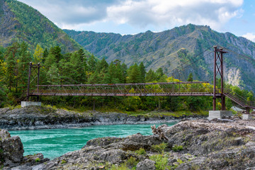 Suspension pedestrian bridge over the Katun river near the village of Elanda