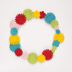 Colorful circular flowers frame on white backdrop