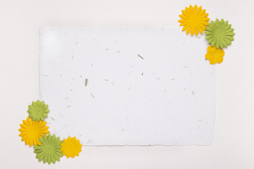 Decorative flowers on the corner of blank paper against white backdrop