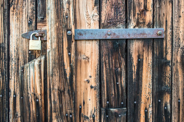 Brown wooden background texture with padlock. Vertical planks, bars