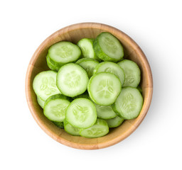 .Fresh cucumber slices in wood bowl isolated on white background. top view