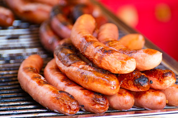 German streetfood, many BBQ grilled sausages ready to eat