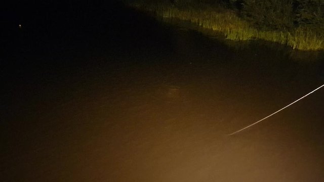 A diver is looking for a drowned man. The search for the drowned. Diver at night.