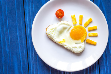 sunshine fried eggs breakfast for kid on blue background