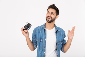 Image of amazed happy man smiling and holding retro camera