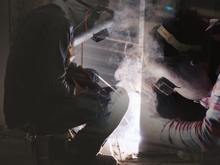 Welding work ,worker with protective welding metal on construction