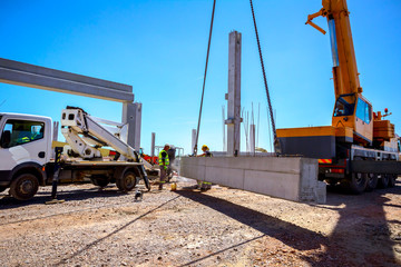 Worker is using grinder for cutting cement pillar excess of material to correct measure