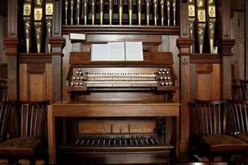 Closeup of an old pipe organ in a church. - obrazy, fototapety, plakaty