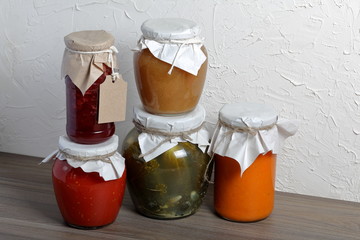 Homemade seasonal preparations. In banks, canned vegetables, fruits. The neck of the cans is...