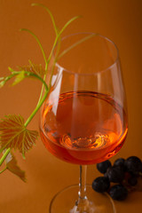 Glass of wine and grape branch