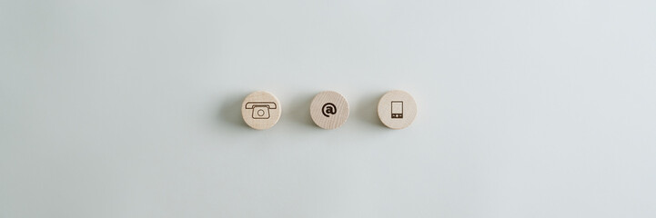 Three wooden circles with contact and communication icons