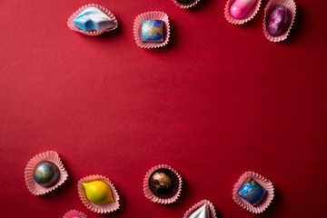 Red chocolate bonbons set background