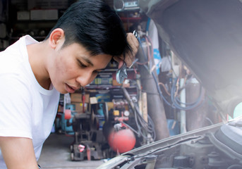 A man is fixing machine of car