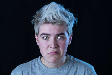 Portrait of a young teenager looking skeptical and displease with something that he dislike