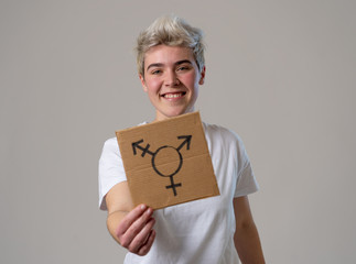 Portrait of happy proud and confident trans teenager man holding transgender symbol