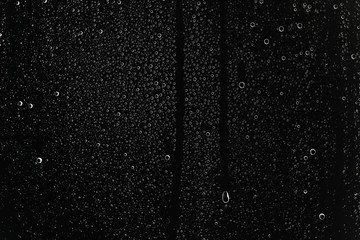 black wet background / raindrops for overlaying on window, concept of autumn weather, background of drops of water rain on glass transparent