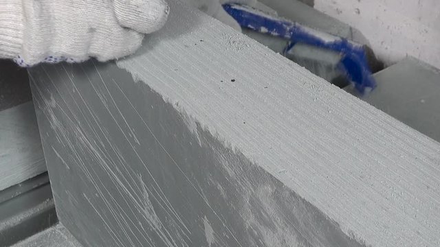 Worker makes apartment renovation, align the edge of the tile with a planer