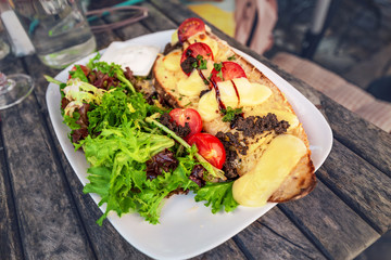 Healthy french breakfast with herbs and toast with cheese and sauce