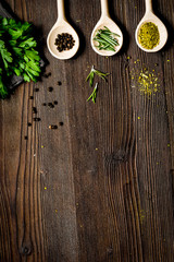 spices and fresh salad on dark wooden table top view
