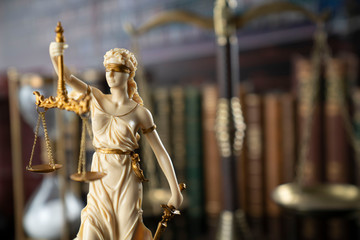 Judge, justice concept background.  Symbol of justice – Themis in the old university library.