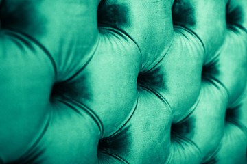 Emerald luxury velour quilted sofa upholstery with buttons, elegant green home decor texture and background