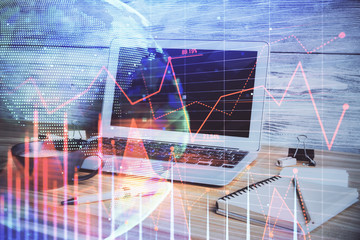 Double exposure of graph and financial info and work space with computer background. Concept of...